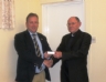Vice President Canon Murphy presents County Chairman John Mc Sparran with a commemorative 125 medal 