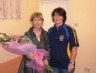 Aileen Hardy presents Anne Cooney with a bouquet of flowers 