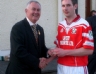 Christy Cooney presents Loughgiel winning captain Odhran Mc Fadden with his commemorative medal 